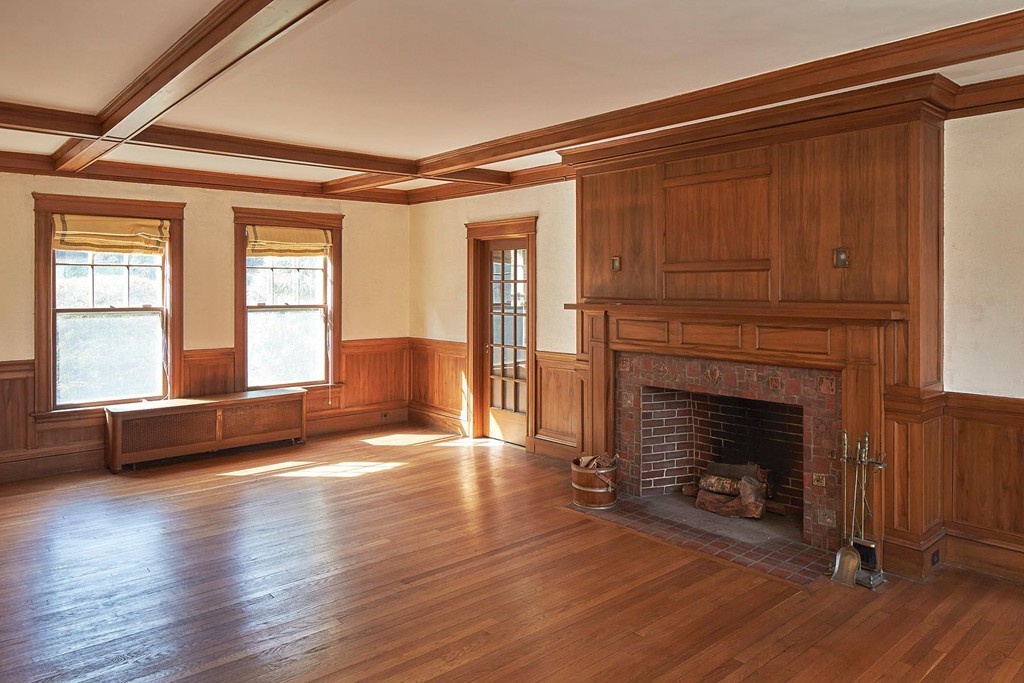 236 Buckminster Road Brookline, MA 02445 - Photo 5 of 8 a view of an empty room with exposed radiator and fireplace