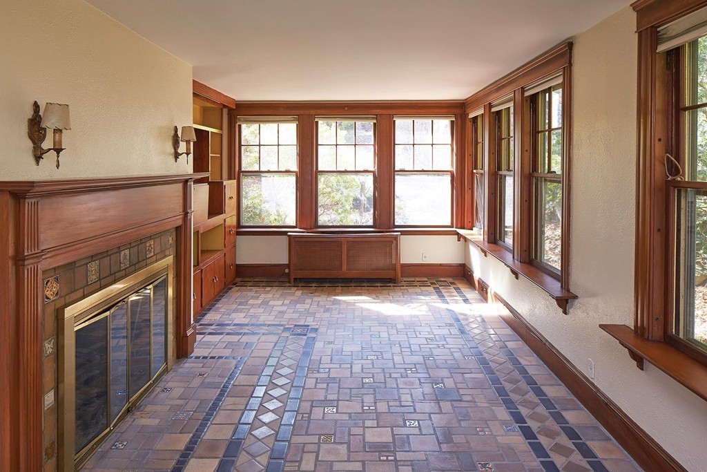 236 Buckminster Road Brookline, MA 02445 - Photo 6 of 8 a view of empty room with a fireplace and windows
