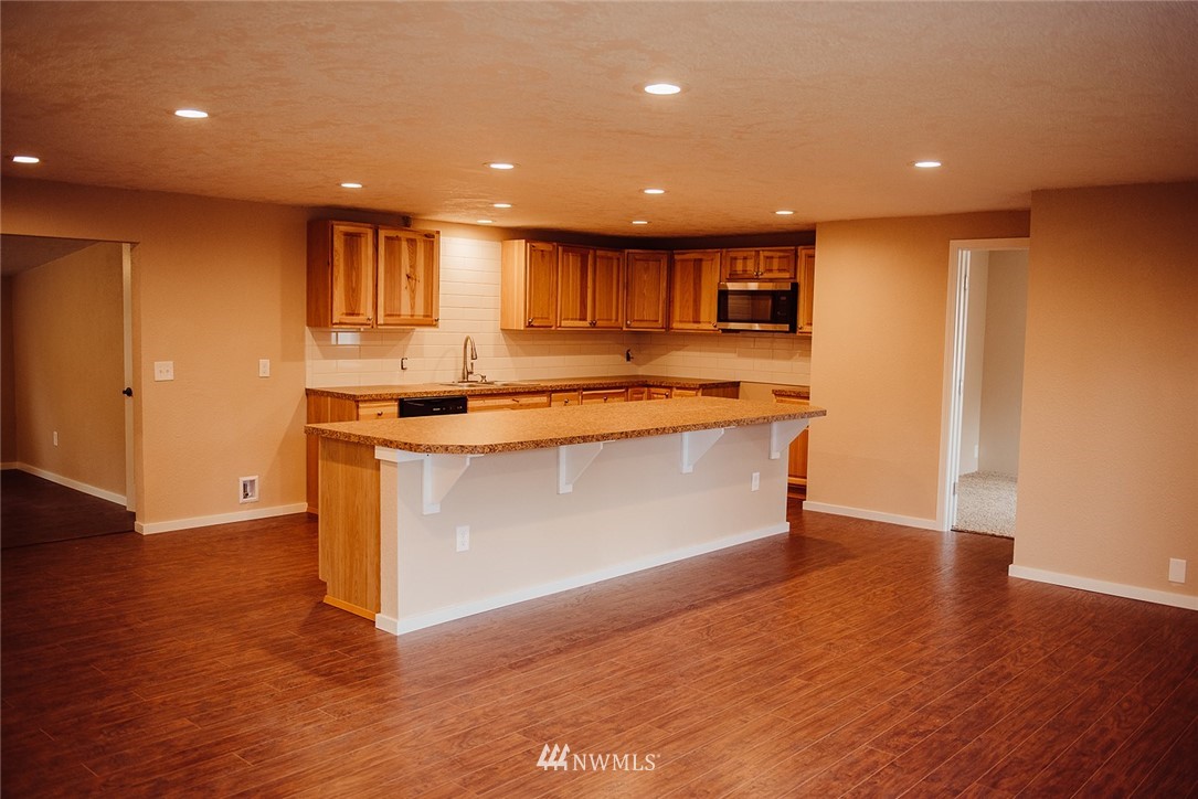 116 Eadon Road Toledo, WA 98591 - Photo 2 of 34 a kitchen with stainless steel appliances granite countertop a sink a stove a refrigerator and a microwave with wooden floor