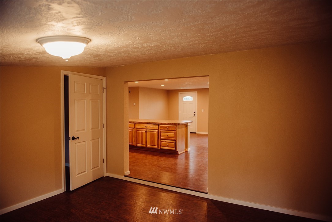 116 Eadon Road Toledo, WA 98591 - Photo 11 of 34 an empty room with wooden floor and mirror