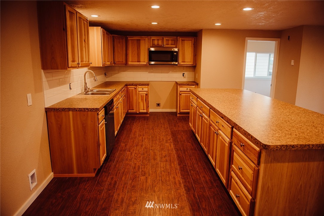 116 Eadon Road Toledo, WA 98591 - Photo 3 of 34 a view of a kitchen with wooden floor and a sink
