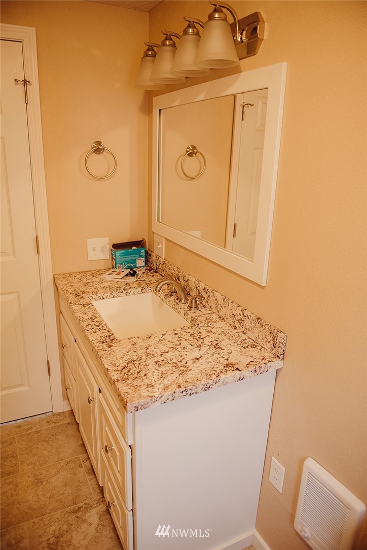 116 Eadon Road Toledo, WA 98591 - Photo 23 of 34 a bathroom with a granite countertop sink and a mirror