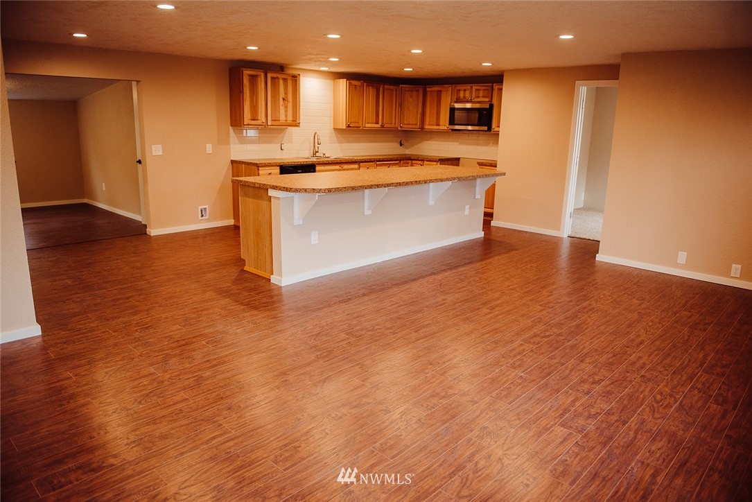 116 Eadon Road Toledo, WA 98591 - Photo 9 of 34 a view of kitchen with kitchen island wooden floor and living room