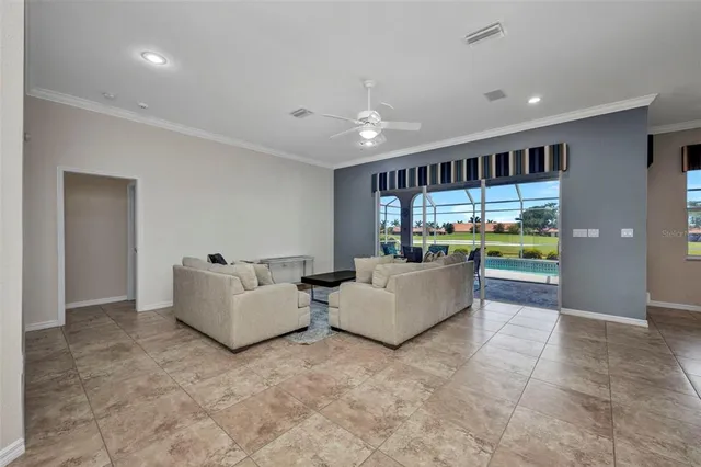 a living room with furniture and chandelier