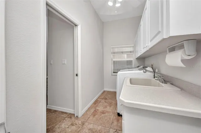 a bathroom with a granite countertop toilet sink and mirror