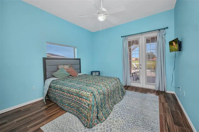 a dining room with furniture and a floor to ceiling window