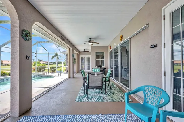 a view of a swimming pool with a bench in front of house