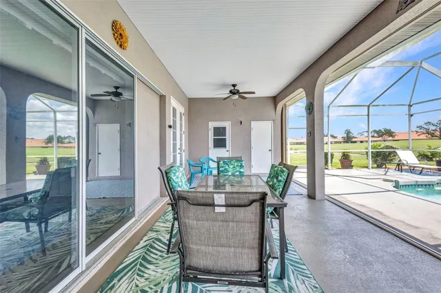 a view of a swimming pool with a yard and plants