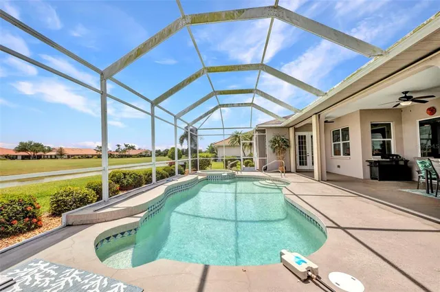 an aerial view of a house with a garden and lake view