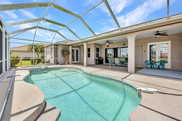an aerial view of a house with a garden and lake view