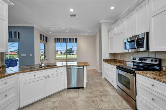 a kitchen with stainless steel appliances a refrigerator sink and stove