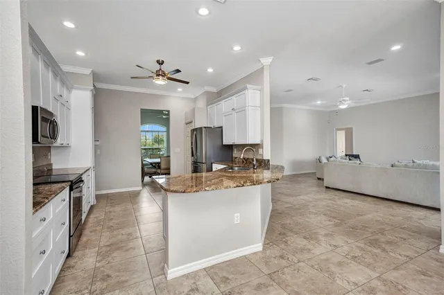 a kitchen with stainless steel appliances granite countertop a stove and a sink