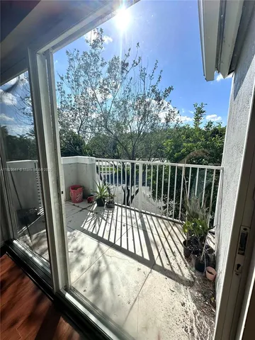 a view of balcony with wooden floor and fence