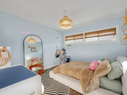 a bedroom with a bed and a chandelier