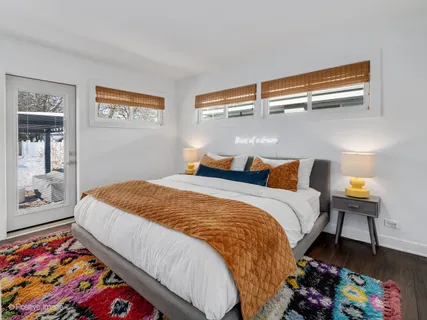 a bed sitting in a bedroom next to a window