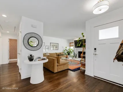 a living room with furniture a rug and a window