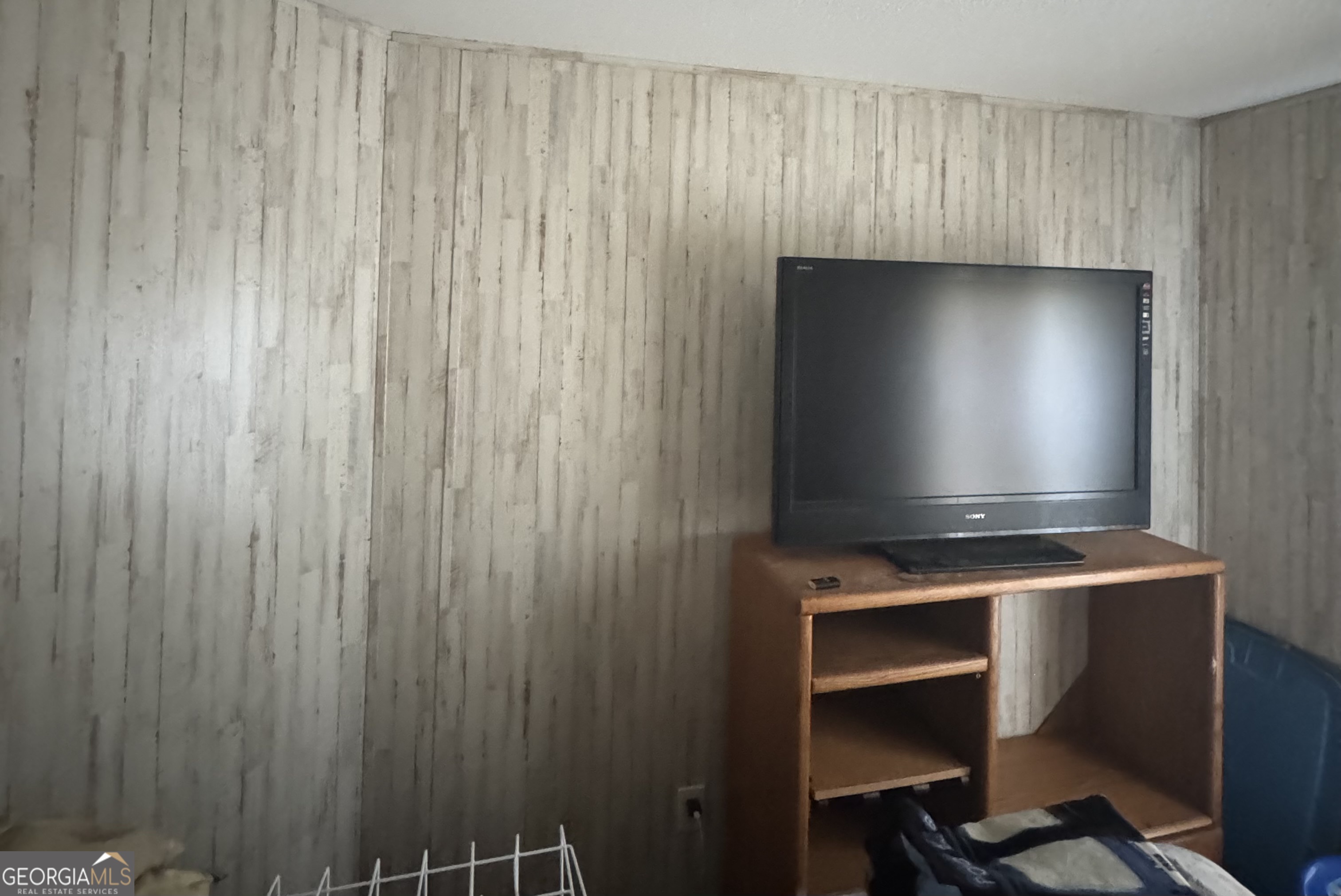 92 Graham Lane Claxton, GA 30417 - Photo 14 of 18 a room with a chair and a flat screen tv