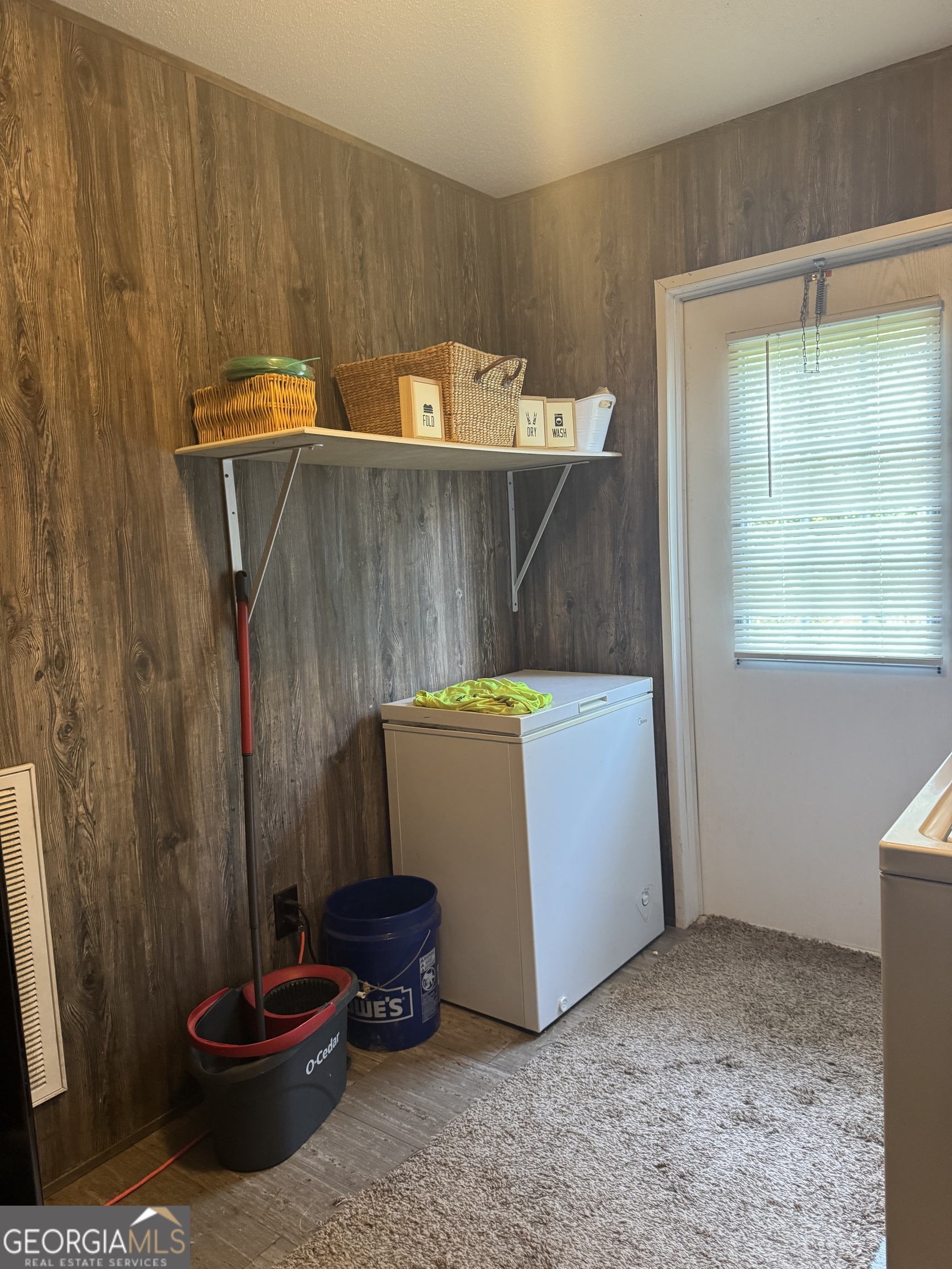 92 Graham Lane Claxton, GA 30417 - Photo 8 of 18 a room with a cabinet and a potted plant