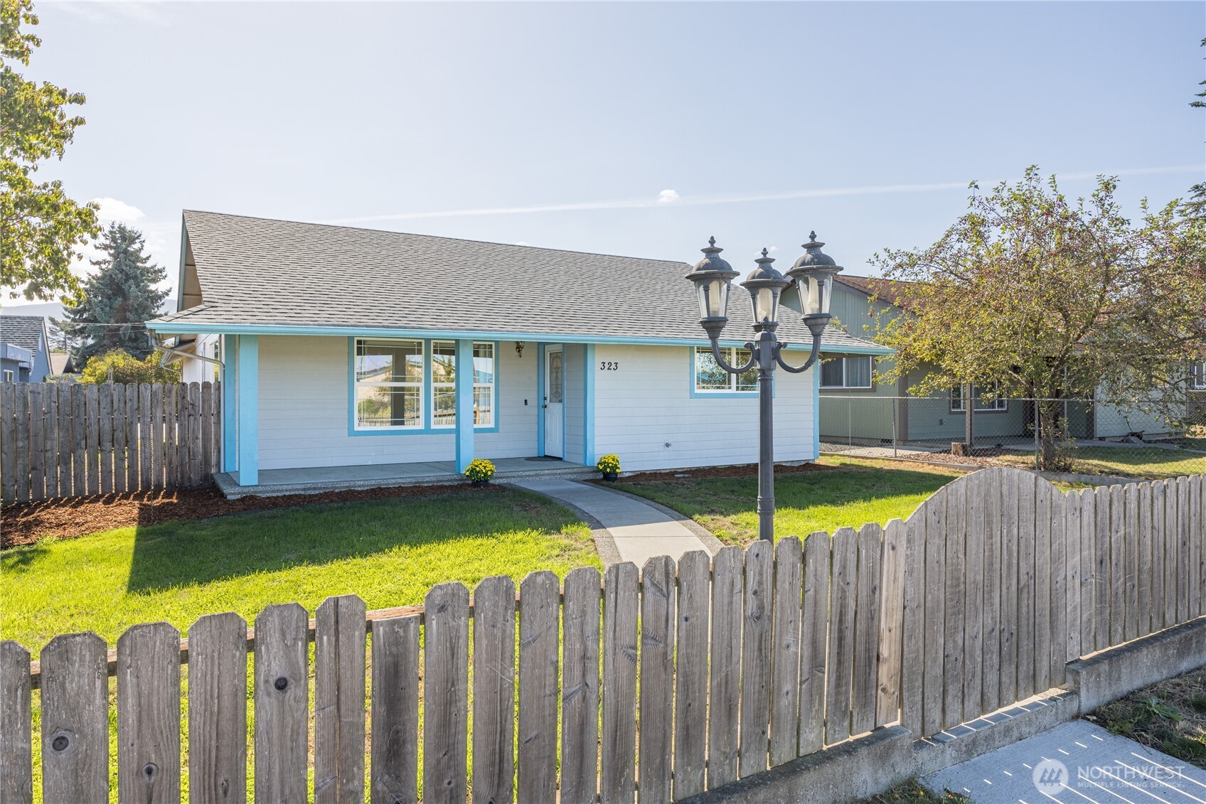 a view of a house with swimming pool and wooden fence