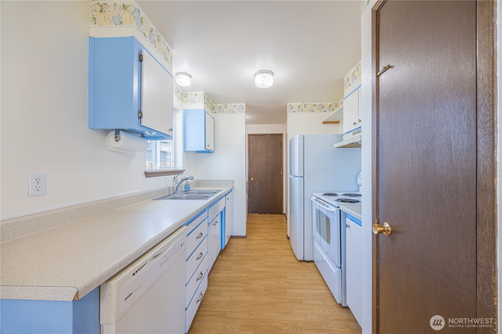 323 West Fir Street Sequim, WA 98382 - Photo 13 of 40 a kitchen with stainless steel appliances a sink and a refrigerator