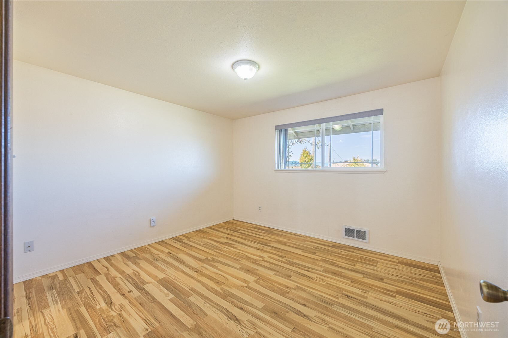 323 West Fir Street Sequim, WA 98382 - Photo 14 of 40 a view of a room with wooden floor and white walls
