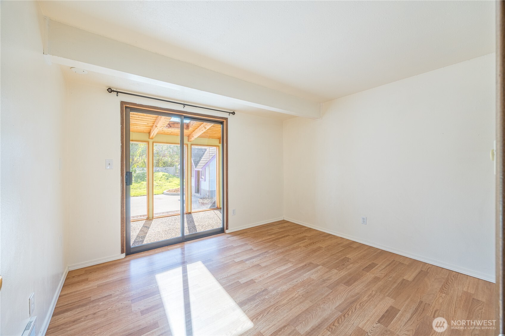 323 West Fir Street Sequim, WA 98382 - Photo 18 of 40 an empty room with wooden floor and windows