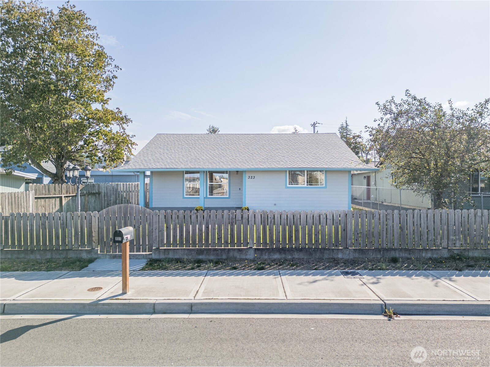 323 West Fir Street Sequim, WA 98382 - Photo 3 of 40 a house that has a tree in front of it