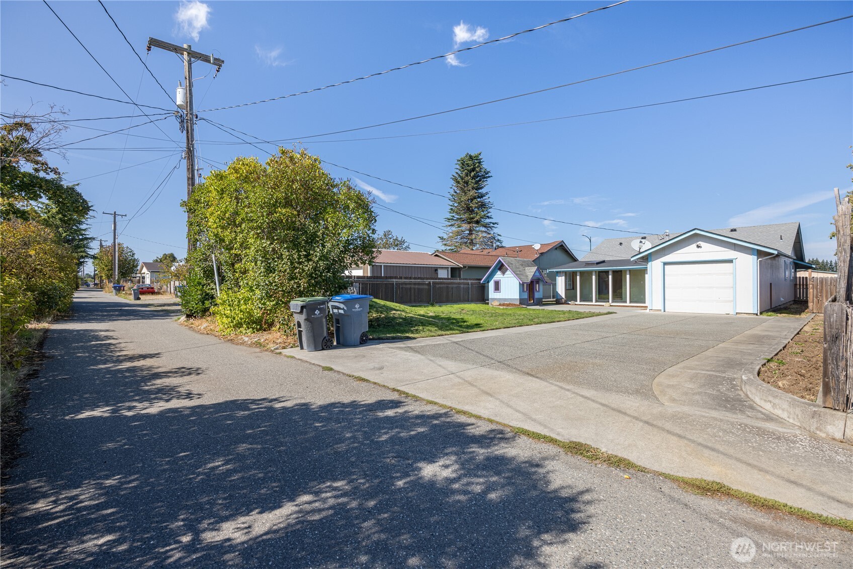 323 West Fir Street Sequim, WA 98382 - Photo 37 of 40 a front view of a house with a yard and garage