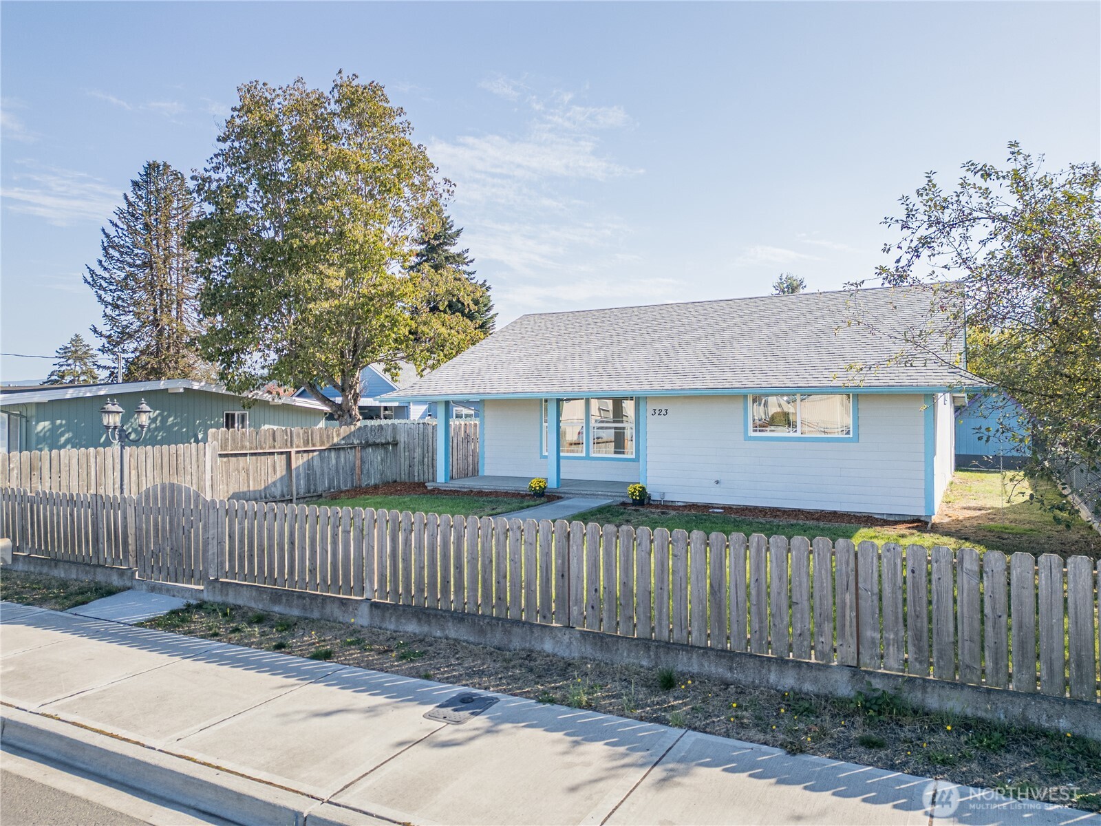 323 West Fir Street Sequim, WA 98382 - Photo 4 of 40 a front view of a house with a fence