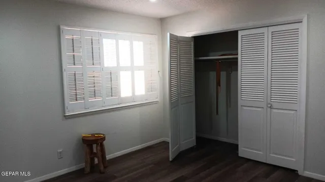 a view of room with window and wooden floor