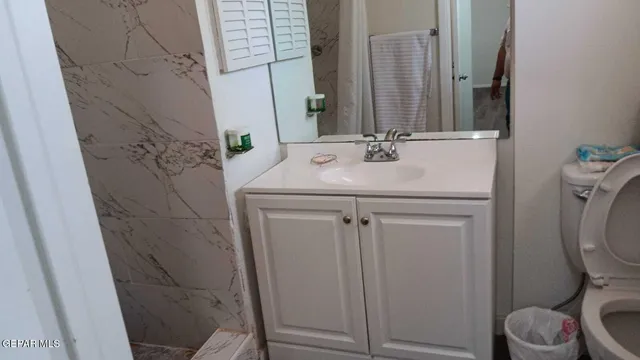 a bathroom with a sink toilet and shower