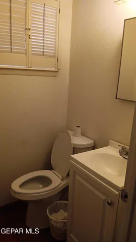 a bathroom with a toilet a sink and a mirror