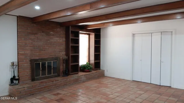 a view of a livingroom with an empty space and a fireplace