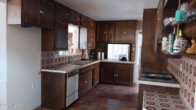 a kitchen with a stove and a sink