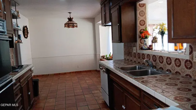 a kitchen with a sink stove and cabinets