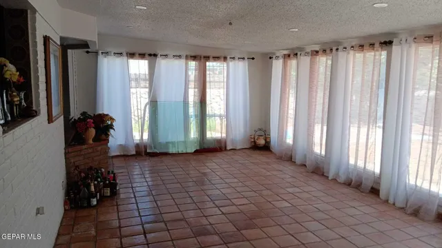 a view of a room with windows and furniture