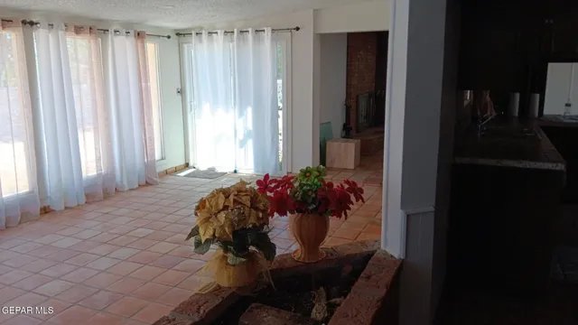 a view of a dining room with furniture and a window