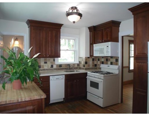 383 Marrett Road Lexington, MA 02421 - Photo 13 of 18 a kitchen with a stove a sink and cabinets