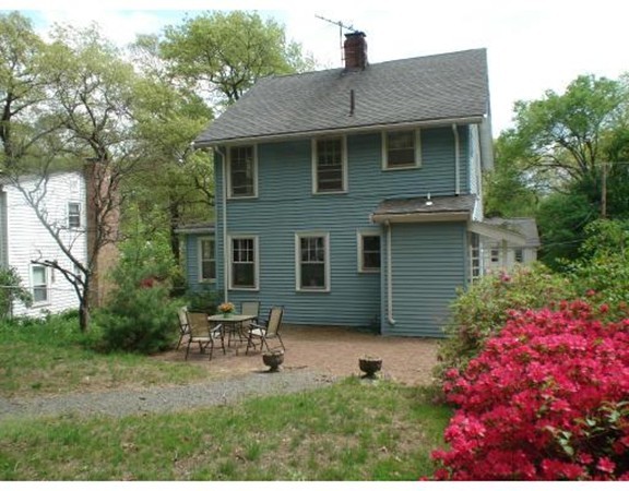383 Marrett Road Lexington, MA 02421 - Photo 3 of 18 a backyard of a house with table and chairs
