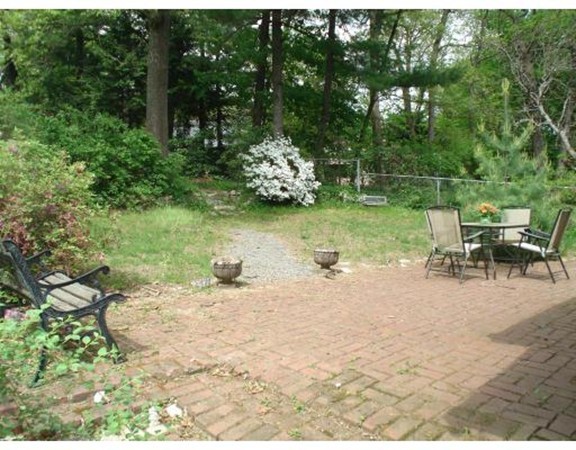 383 Marrett Road Lexington, MA 02421 - Photo 4 of 18 a backyard of a house with table and chairs