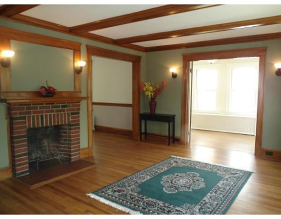 383 Marrett Road Lexington, MA 02421 - Photo 6 of 18 a view of living room with furniture and a fireplace