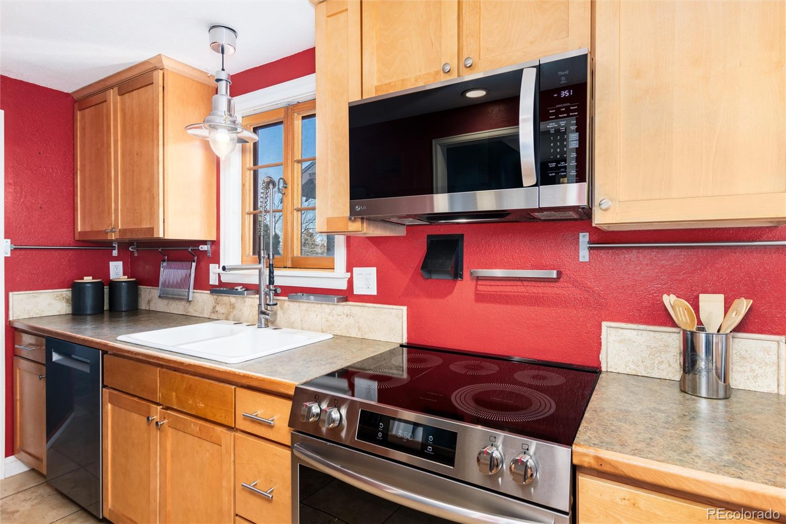 3100 Ames Street Wheat Ridge, CO 80214 - Photo 15 of 39 a kitchen with stainless steel appliances granite countertop a sink and a microwave
