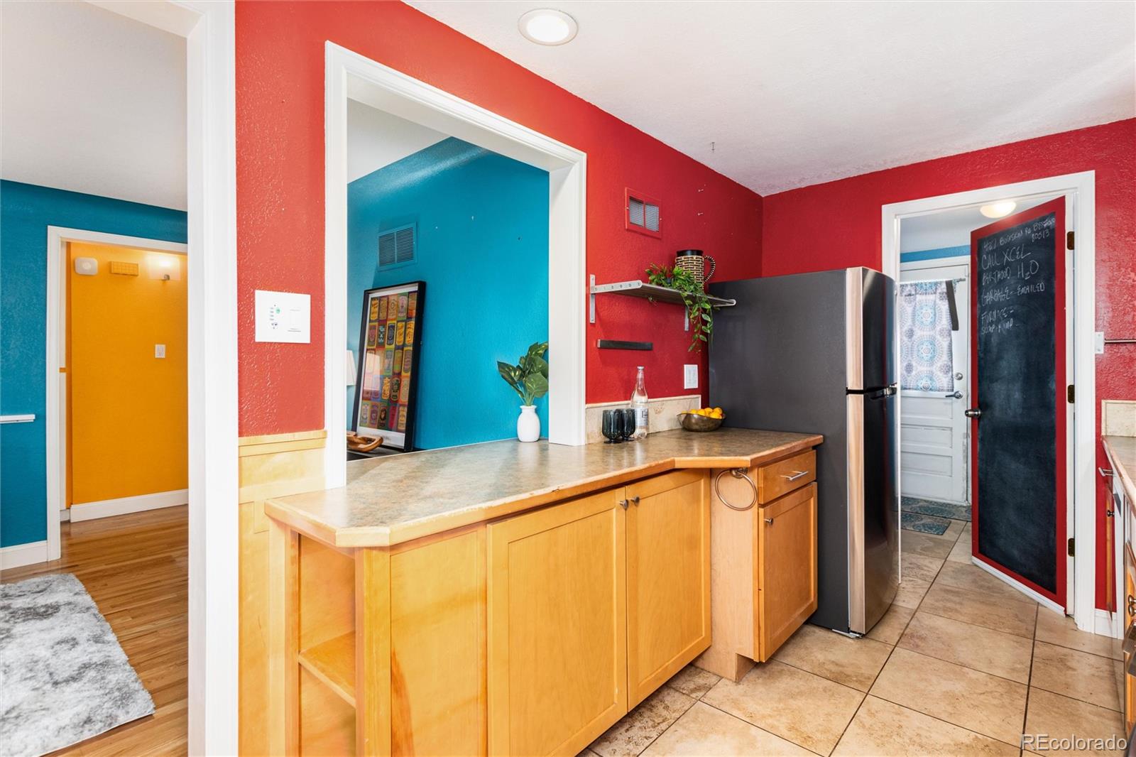 3100 Ames Street Wheat Ridge, CO 80214 - Photo 16 of 39 a kitchen with stainless steel appliances granite countertop a refrigerator and a sink