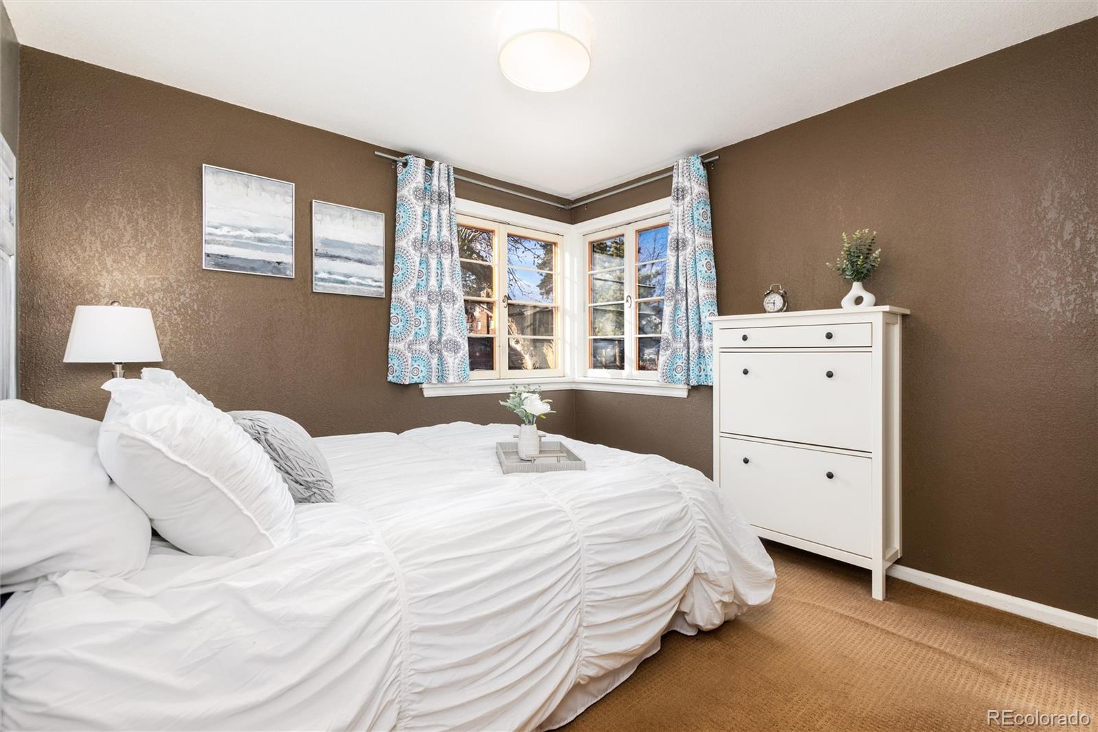 3100 Ames Street Wheat Ridge, CO 80214 - Photo 22 of 39 a bedroom with a white bed and a window