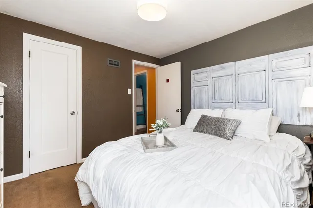 a bedroom with a bed and a closet