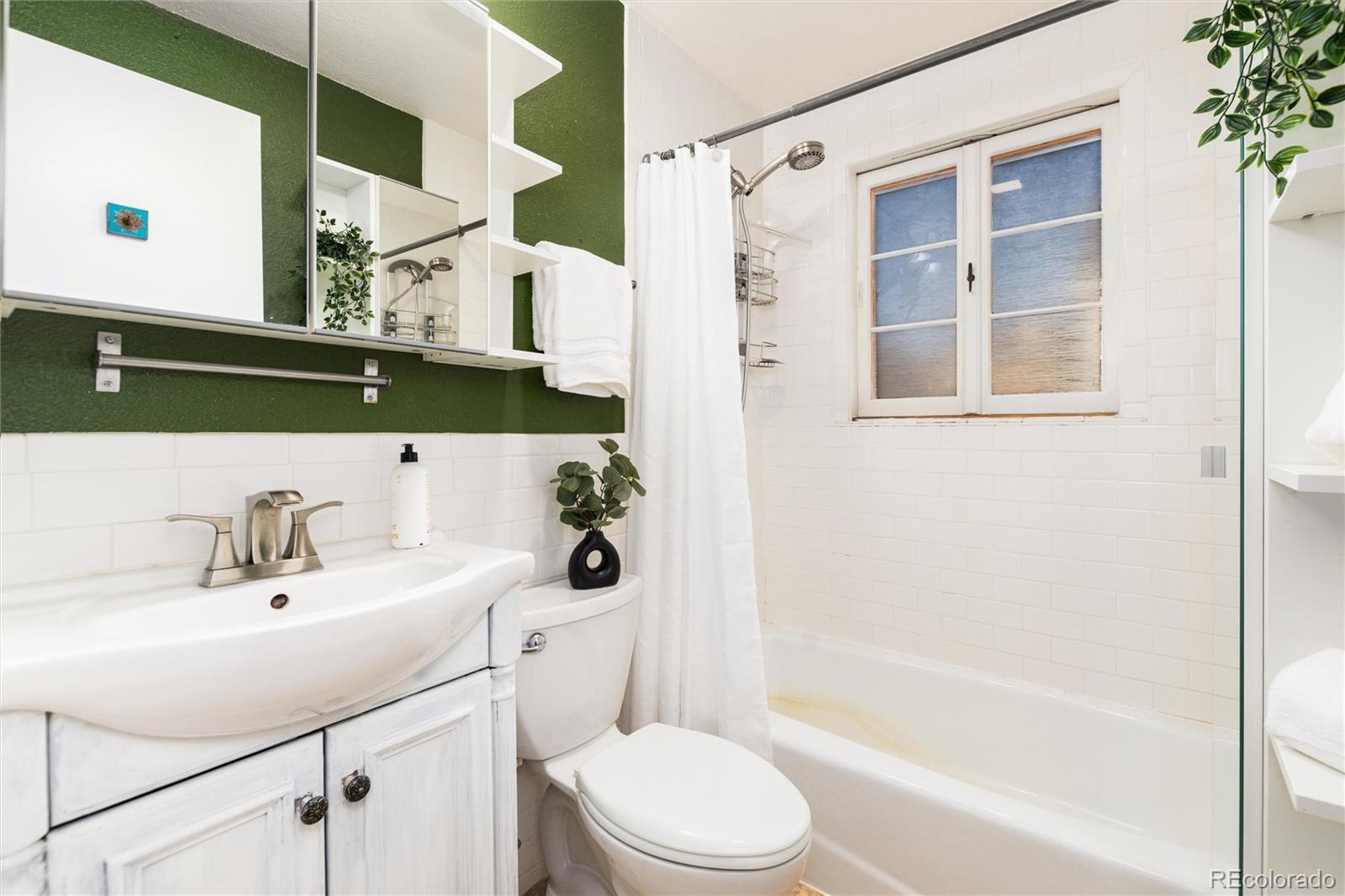 3100 Ames Street Wheat Ridge, CO 80214 - Photo 25 of 39 a bathroom with a sink toilet and shower