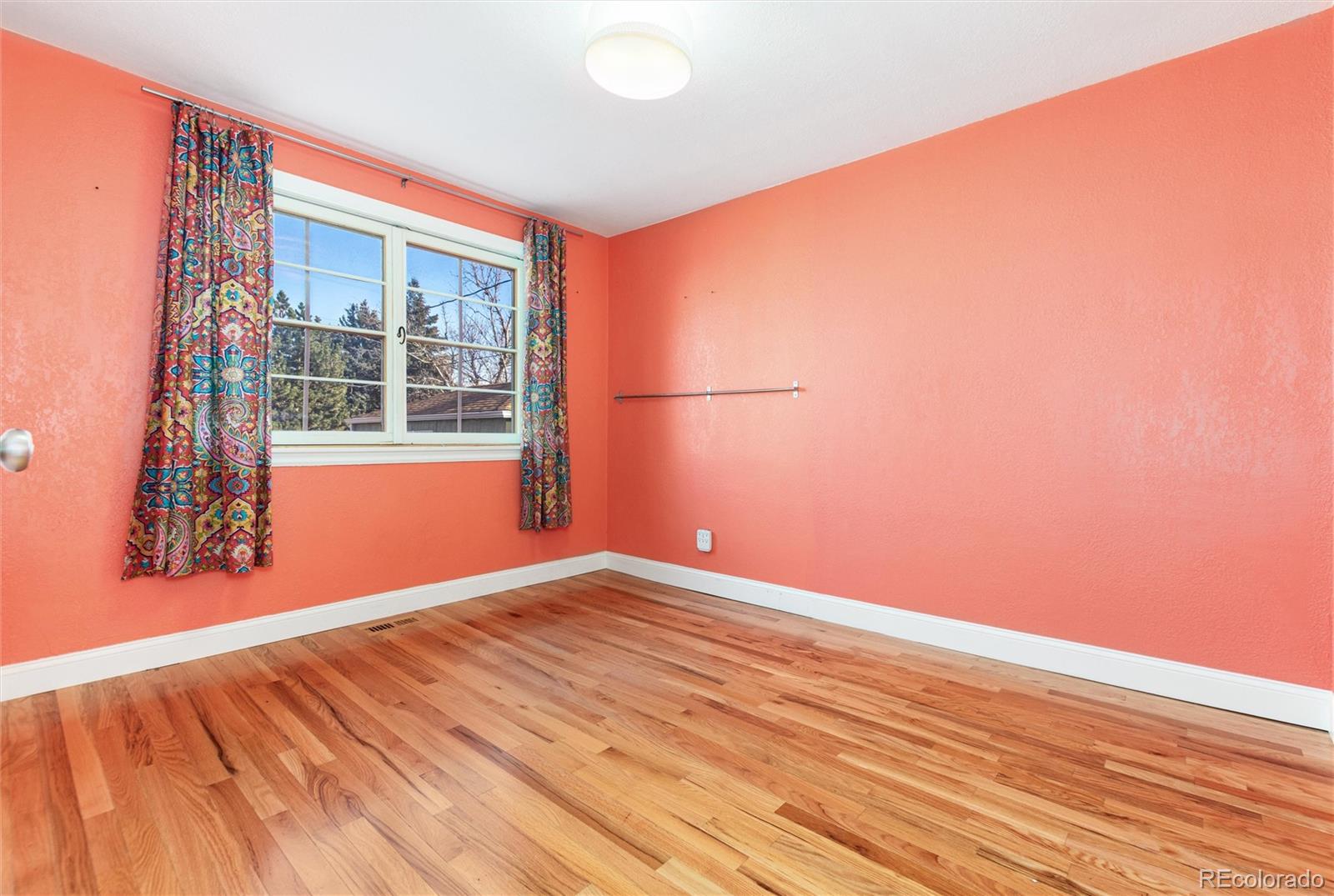3100 Ames Street Wheat Ridge, CO 80214 - Photo 26 of 39 an empty room with wooden floor and windows
