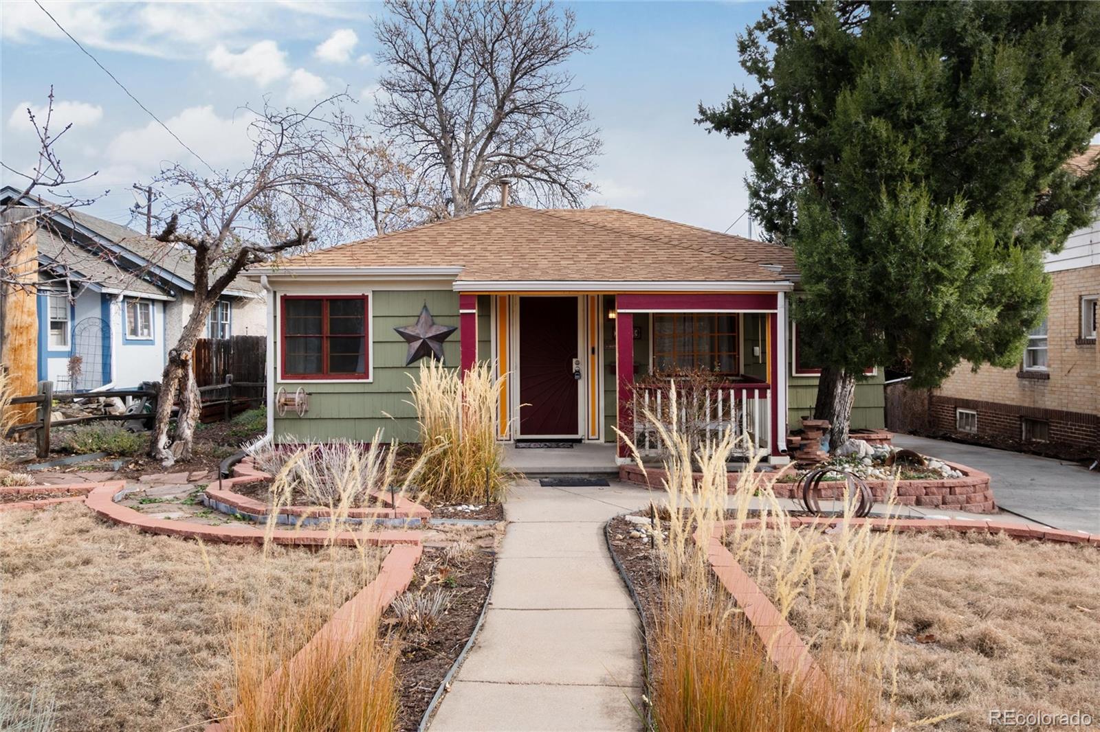 3100 Ames Street Wheat Ridge, CO 80214 - Photo 37 of 39 a view of a patio with table and chairs with wooden fence and large trees