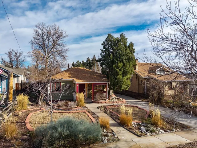 a view of a house with a yard covered with snow in front of house