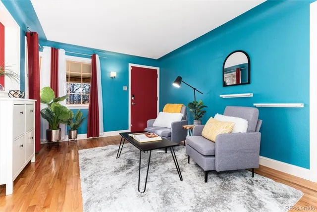 a living room with furniture and wooden floor
